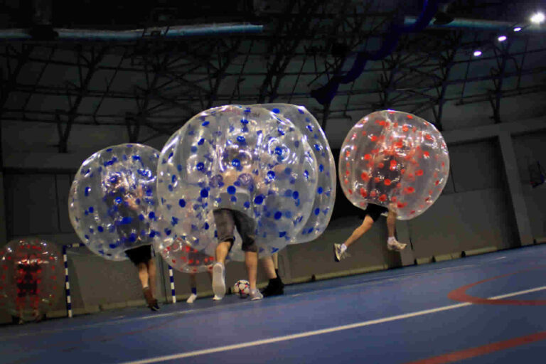 Players in inflatable balls during a bubble football match